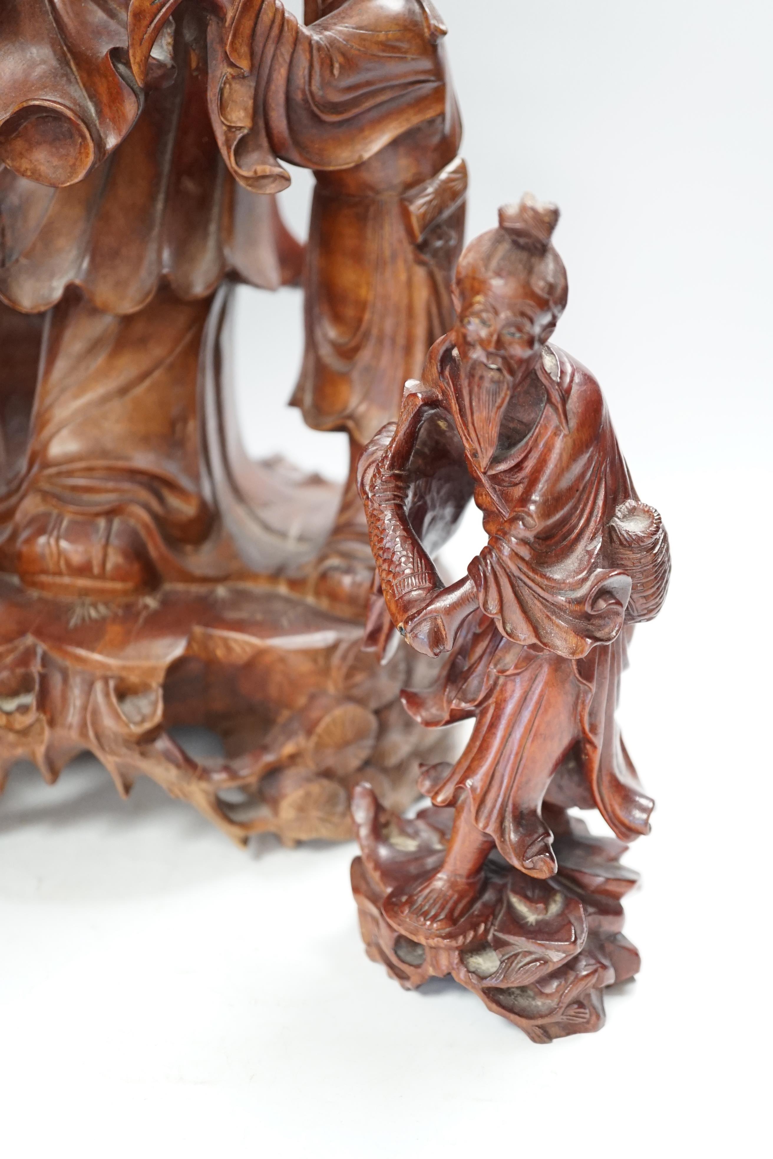 A large Chinese carved wooden figure group of Shou Lao and a pair of small carved figures, figure group 52cm high